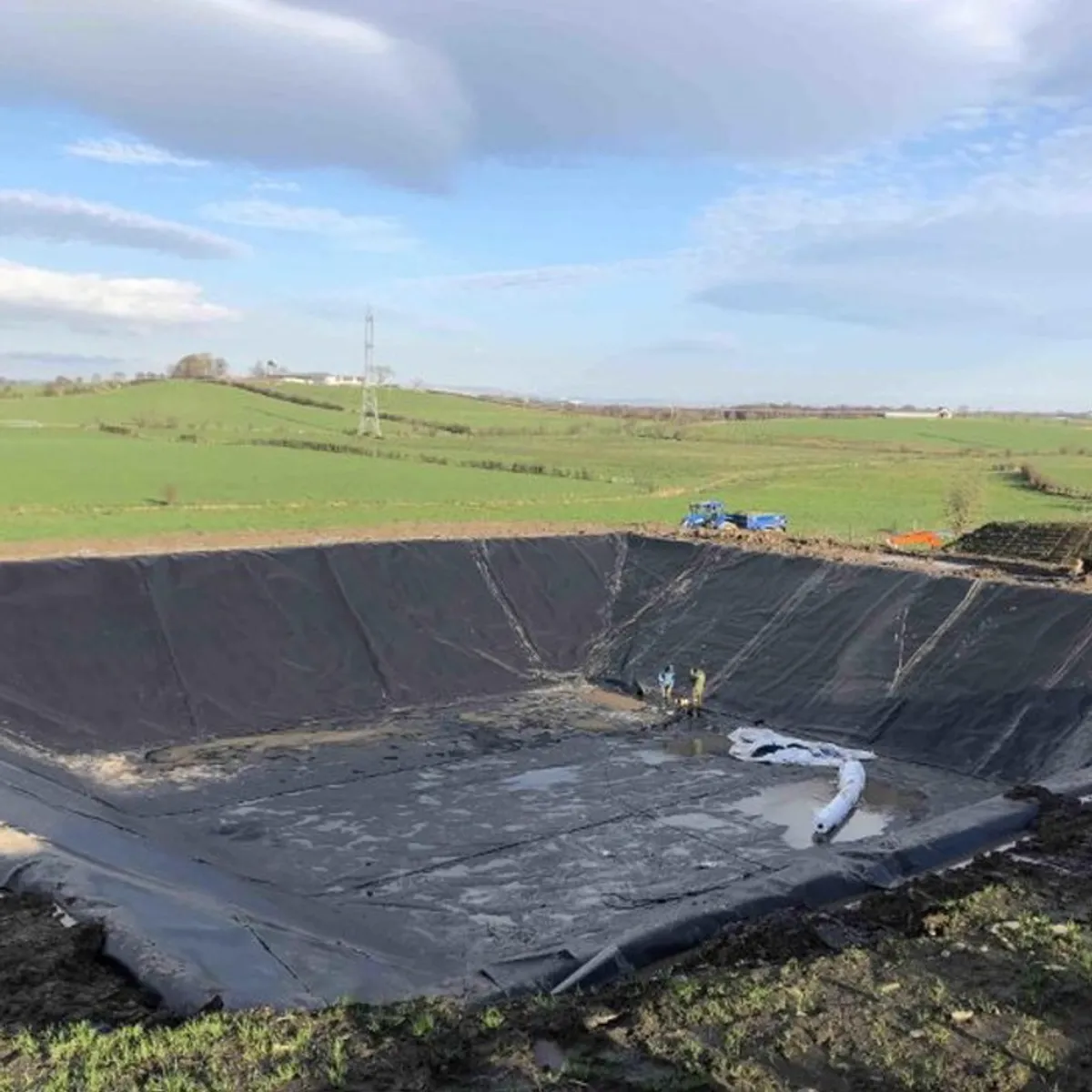 HDPE geomembrane lining the floor and berm walls of a secondary containment basin